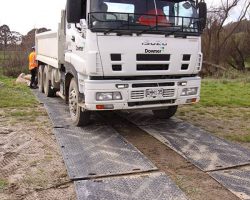 ProtectaMats Used In A Construction Project Downer Truck On Grass Soil