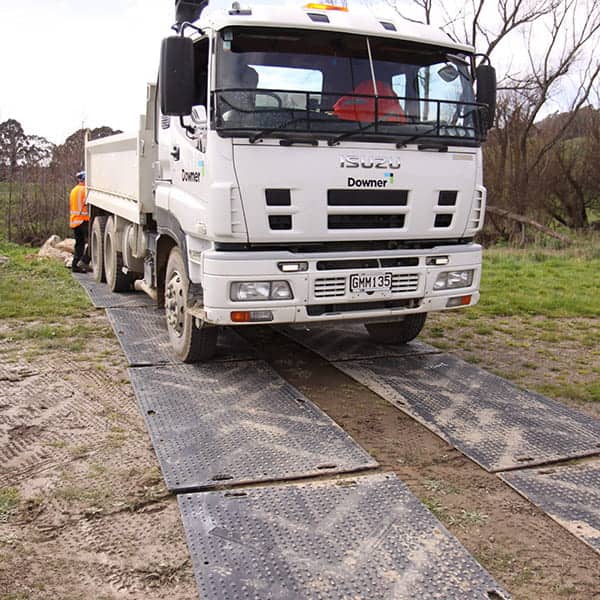 ProtectaMats used in a construction project Downer truck on grass soil