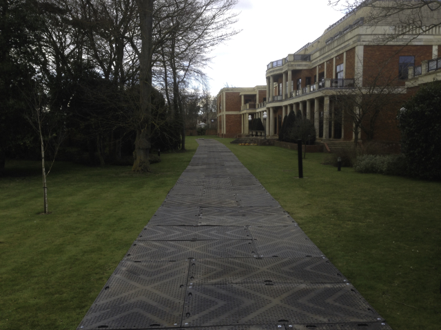 protectamats being used to create a path over grass and turf at a heritage building