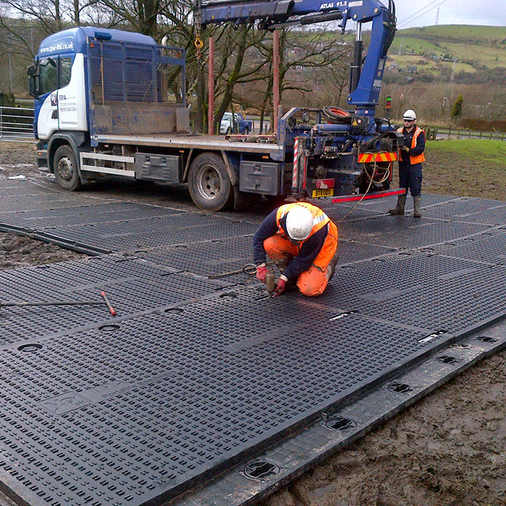 Tufftrak Heavy Duty Ground Protection Mat connected together to form a roadway
